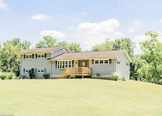 view of front of house featuring a front lawn and a wooden deck