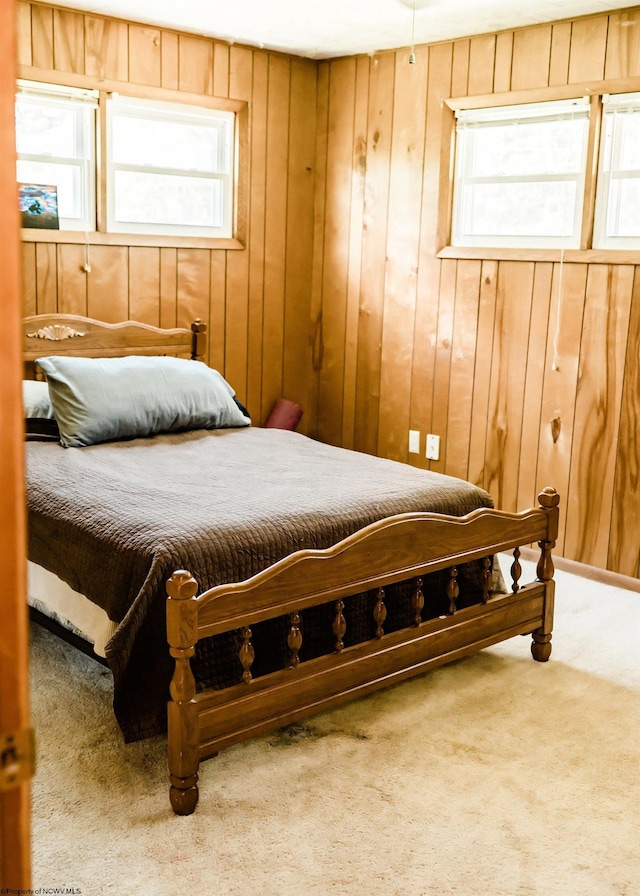 bedroom with wood walls and carpet floors