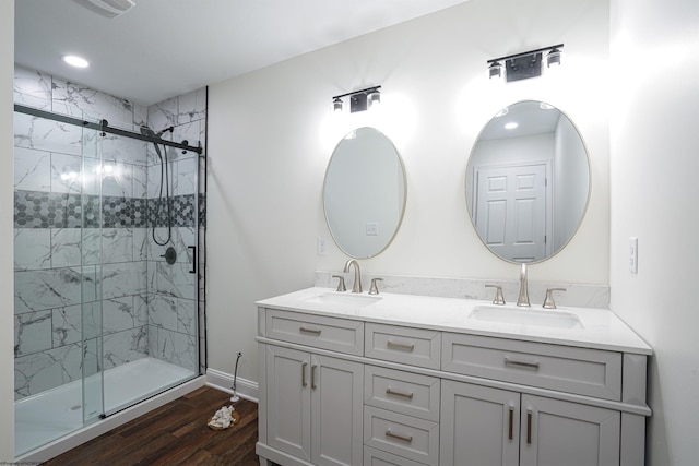 bathroom with vanity, hardwood / wood-style flooring, and a shower with shower door