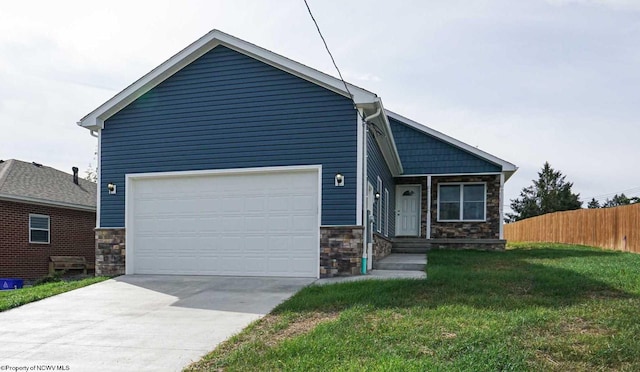 view of front of home with a garage and a front lawn