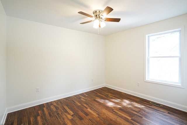 unfurnished room with a wealth of natural light, ceiling fan, and dark hardwood / wood-style floors