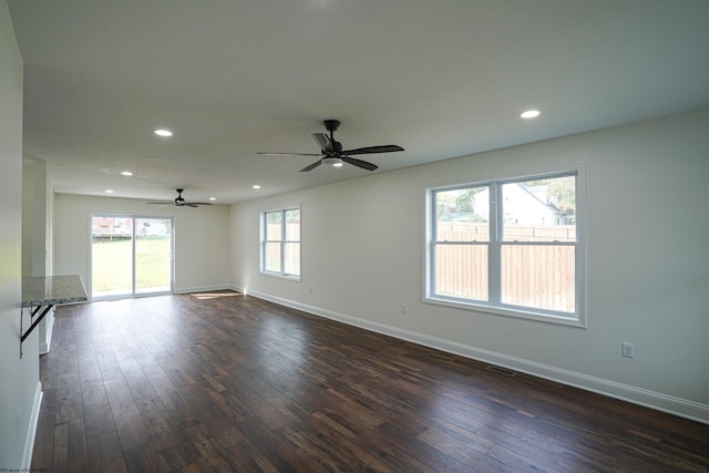 unfurnished room with ceiling fan and dark wood-type flooring