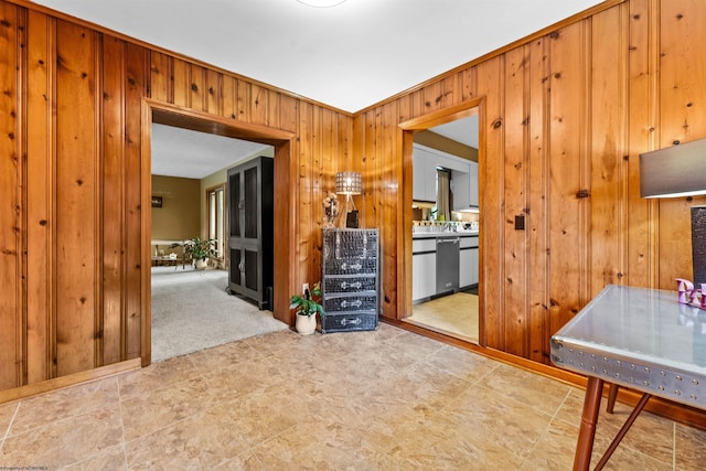 interior space with wood walls, carpet, and ornamental molding