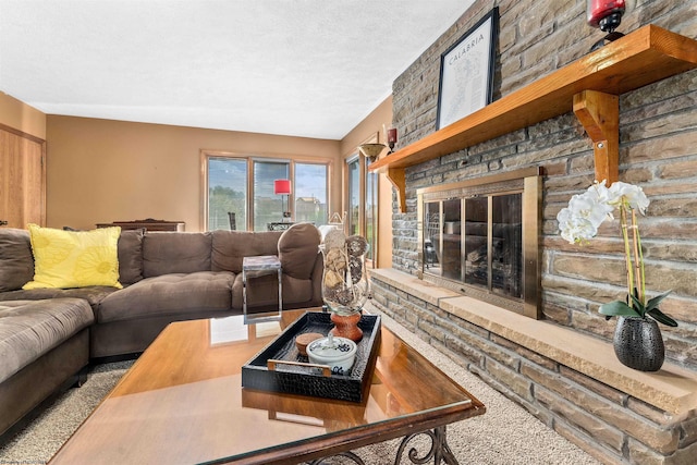 living room featuring a large fireplace, carpet floors, and a textured ceiling