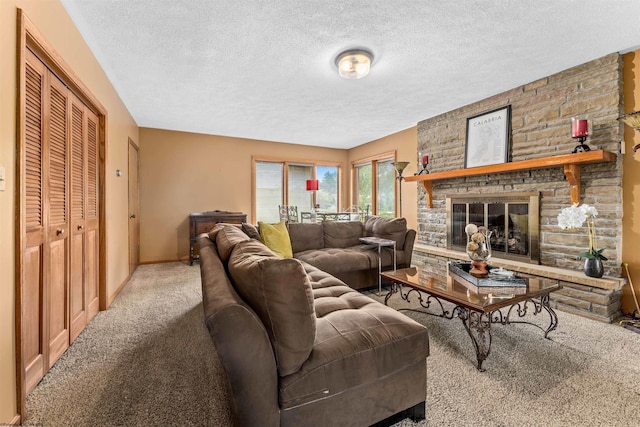 living room with a fireplace, light colored carpet, and a textured ceiling