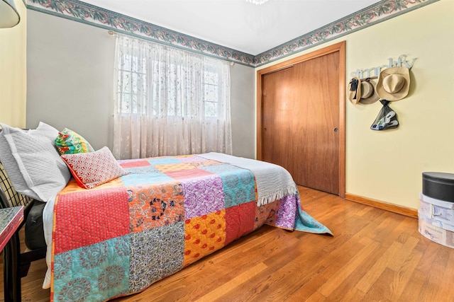 bedroom with a closet and hardwood / wood-style flooring