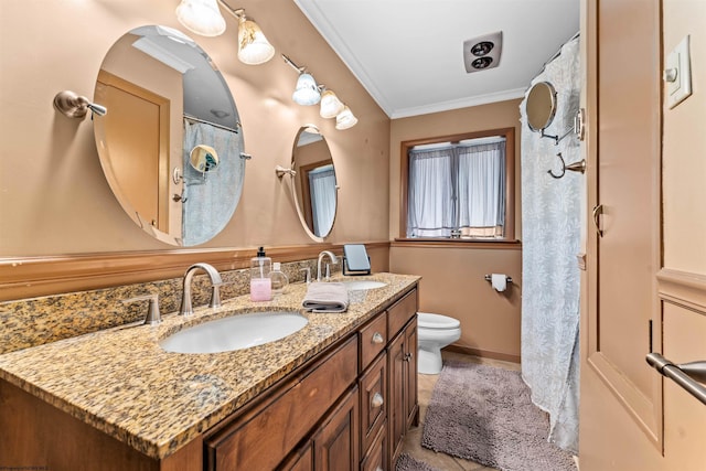 bathroom with tile patterned flooring, vanity, toilet, and crown molding