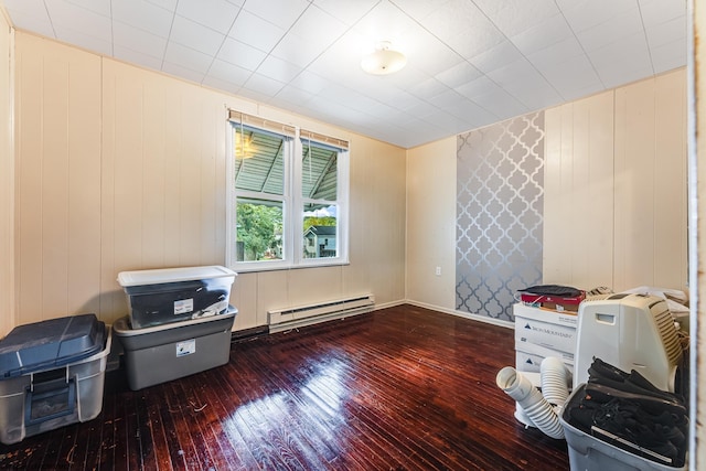 misc room featuring a baseboard heating unit and hardwood / wood-style floors