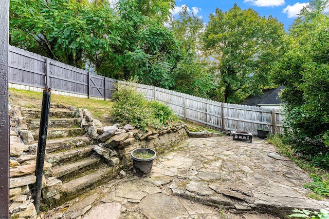 view of yard with a patio and an outdoor fire pit