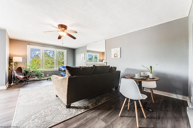 living room with crown molding, ceiling fan, hardwood / wood-style floors, and a textured ceiling