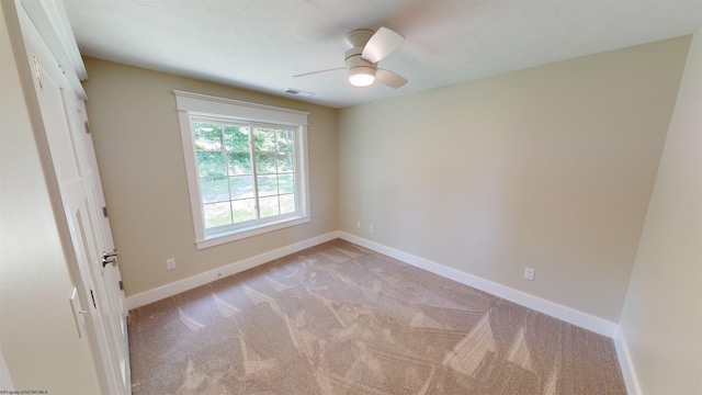 unfurnished bedroom featuring ceiling fan, light colored carpet, and a closet