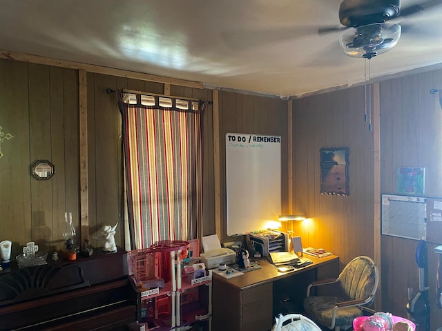 office space featuring wooden walls and ceiling fan