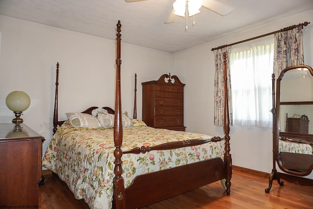 bedroom with ceiling fan and hardwood / wood-style flooring