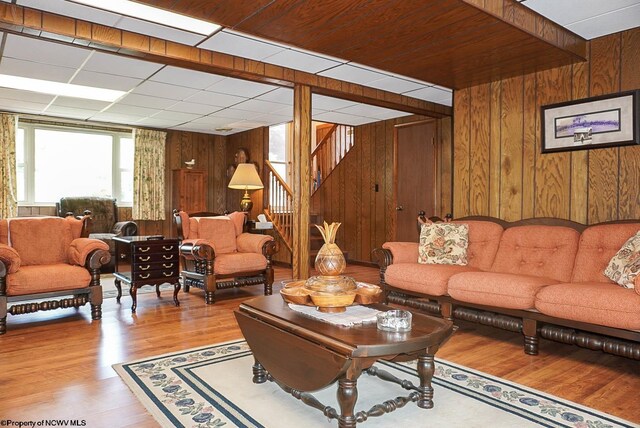 living room with wooden walls and hardwood / wood-style flooring