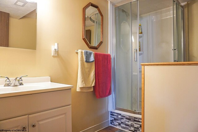 bathroom with vanity with extensive cabinet space and a textured ceiling