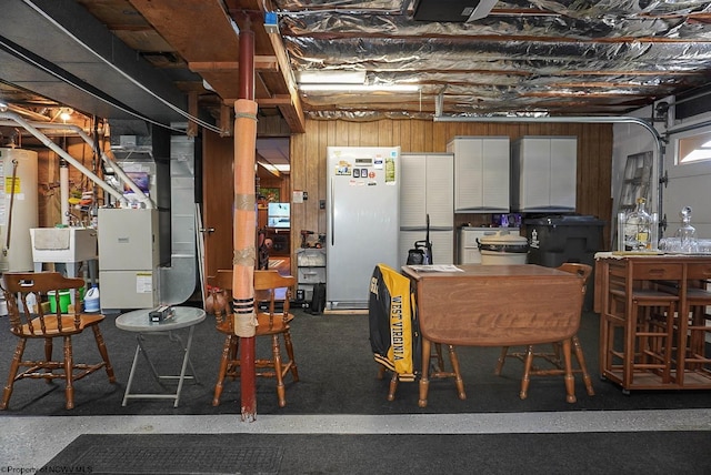 basement with heating utilities and white fridge