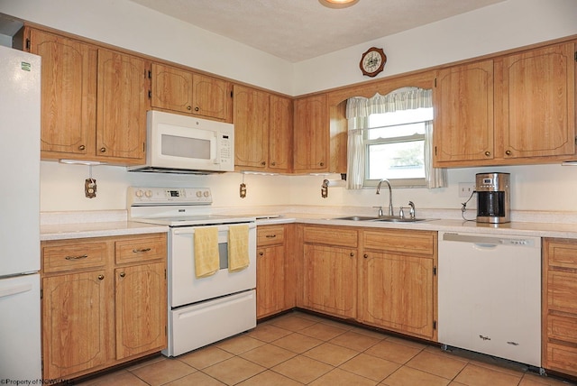 kitchen with white appliances, sink, and light tile floors