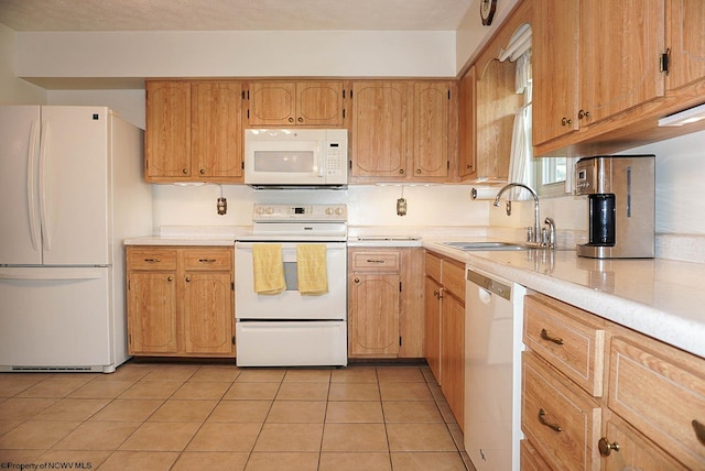 kitchen featuring sink, light tile flooring, and white appliances