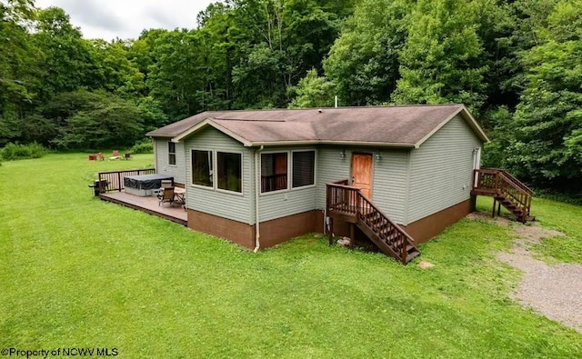 view of front of house featuring a wooden deck and a front lawn