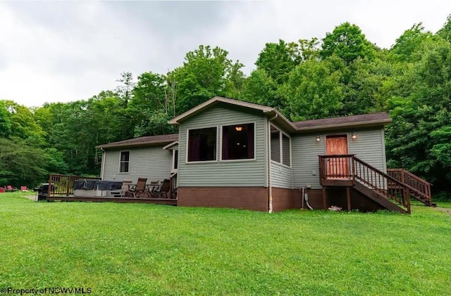 back of property featuring a deck and a yard