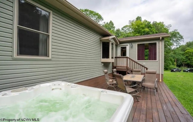 wooden terrace featuring a yard and an outdoor hot tub