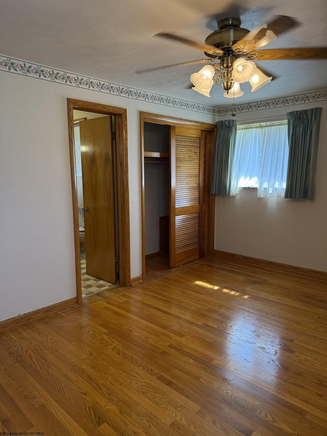 unfurnished bedroom featuring a closet, ceiling fan, and hardwood / wood-style floors