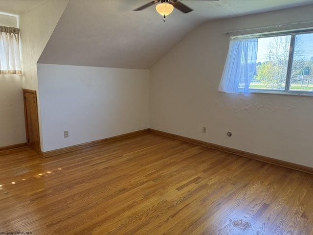 bonus room featuring hardwood / wood-style flooring, vaulted ceiling, and ceiling fan