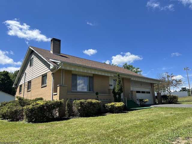 ranch-style house featuring a garage and a front lawn