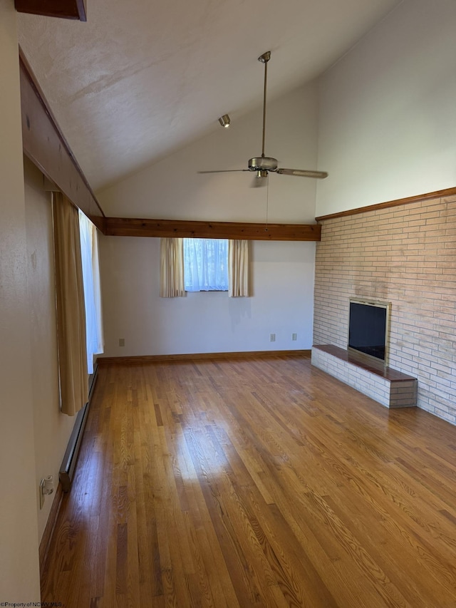 unfurnished living room with vaulted ceiling, hardwood / wood-style flooring, ceiling fan, baseboard heating, and a fireplace