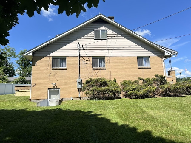 view of side of home featuring a lawn