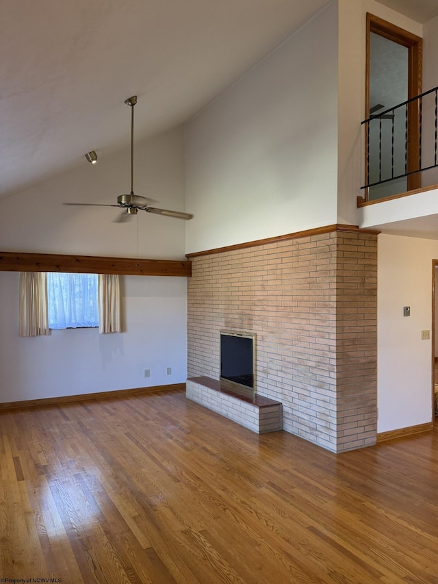 unfurnished living room featuring a brick fireplace, high vaulted ceiling, light hardwood / wood-style flooring, and ceiling fan