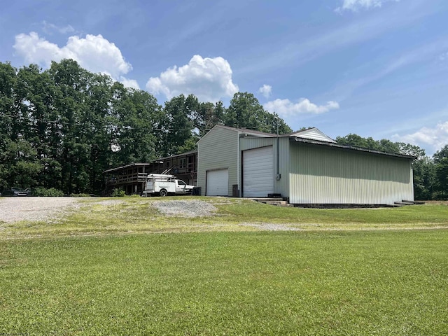 view of outbuilding with a garage and a lawn