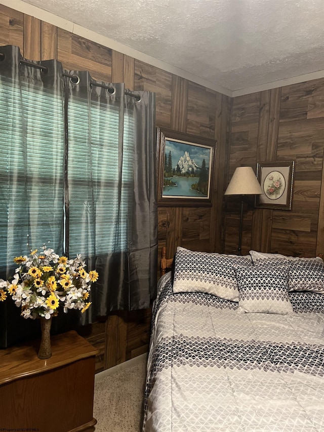 bedroom with a textured ceiling and wooden walls