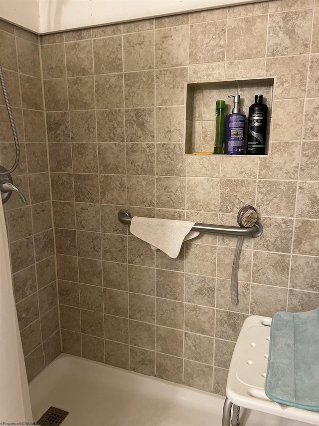 bathroom with a tile shower