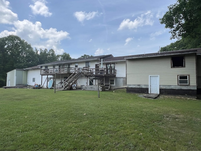 rear view of house with a lawn, a shed, and a deck