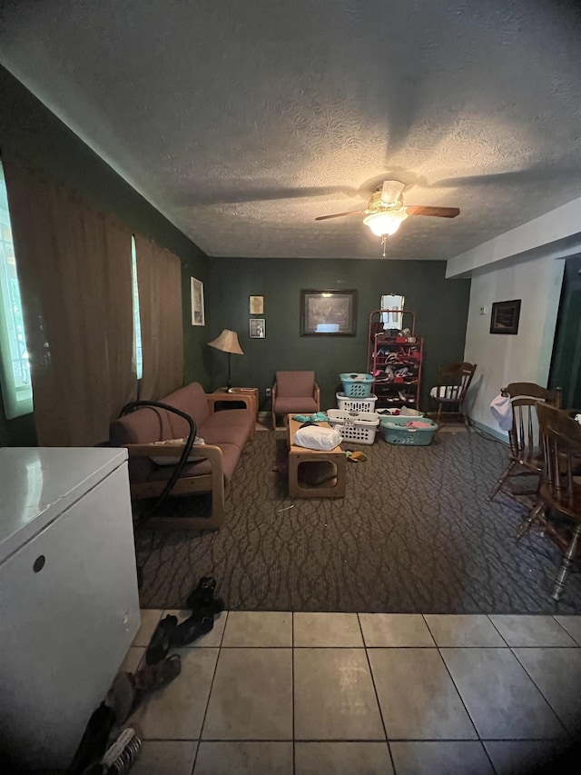 dining room featuring ceiling fan, tile patterned flooring, and a textured ceiling