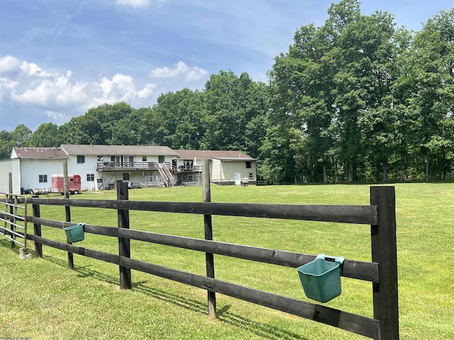 view of front facade with a rural view and a front lawn