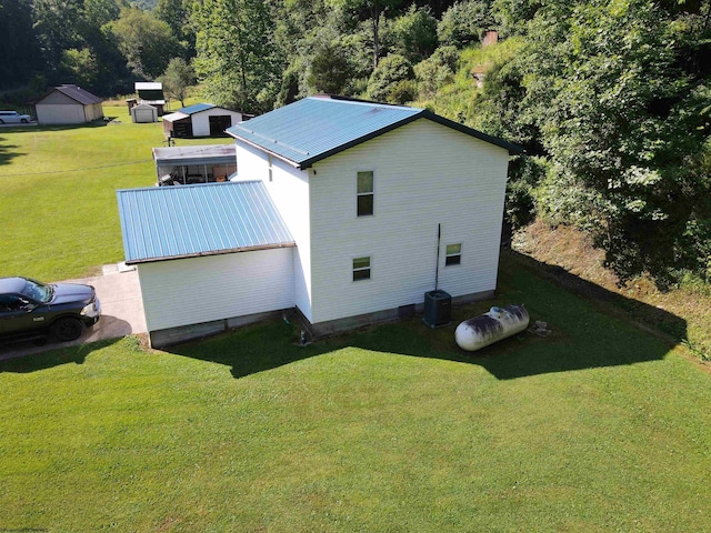 view of home's exterior featuring a lawn and cooling unit