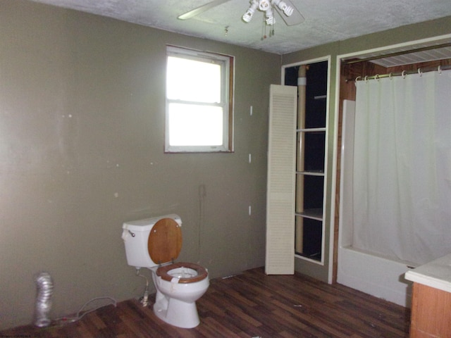 bathroom featuring shower / tub combo with curtain, ceiling fan, wood-type flooring, and toilet