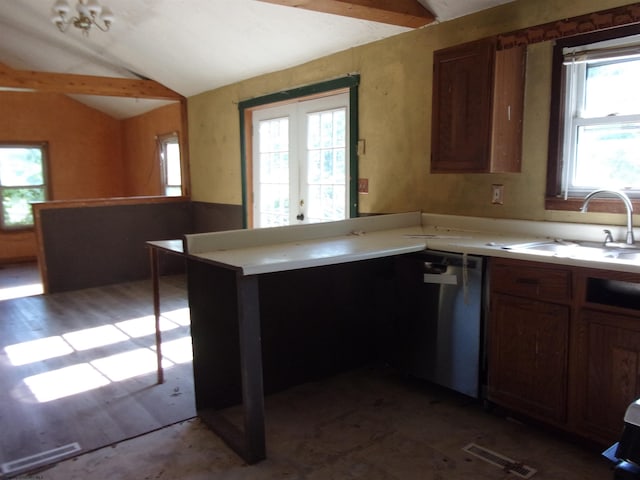 kitchen with vaulted ceiling, dishwasher, sink, and kitchen peninsula