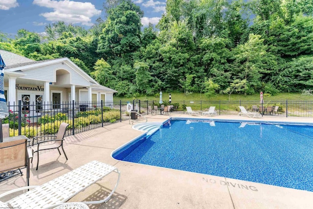 view of pool featuring an outdoor structure and a patio area