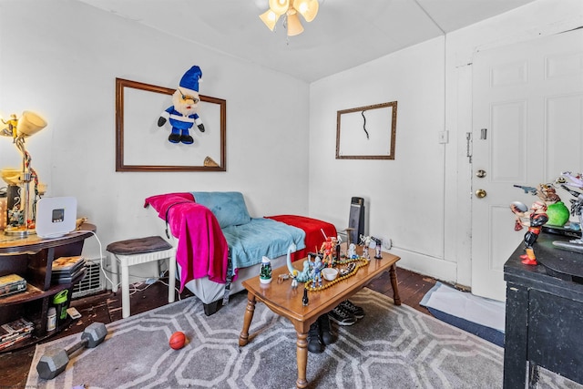 living room with dark hardwood / wood-style flooring and ceiling fan