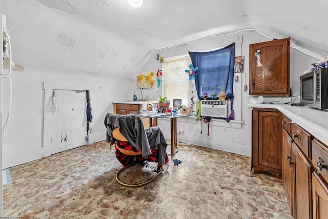 kitchen with lofted ceiling and cooling unit