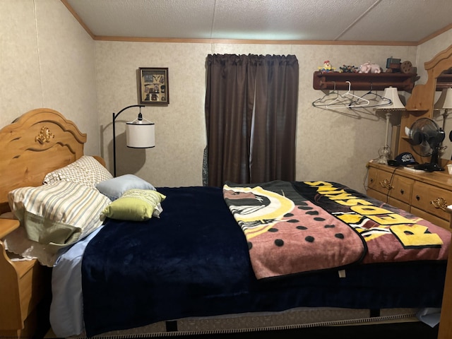 bedroom with crown molding and a textured ceiling