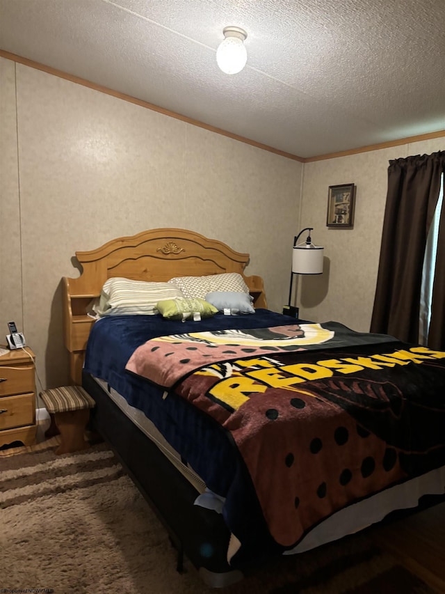 bedroom featuring crown molding and a textured ceiling