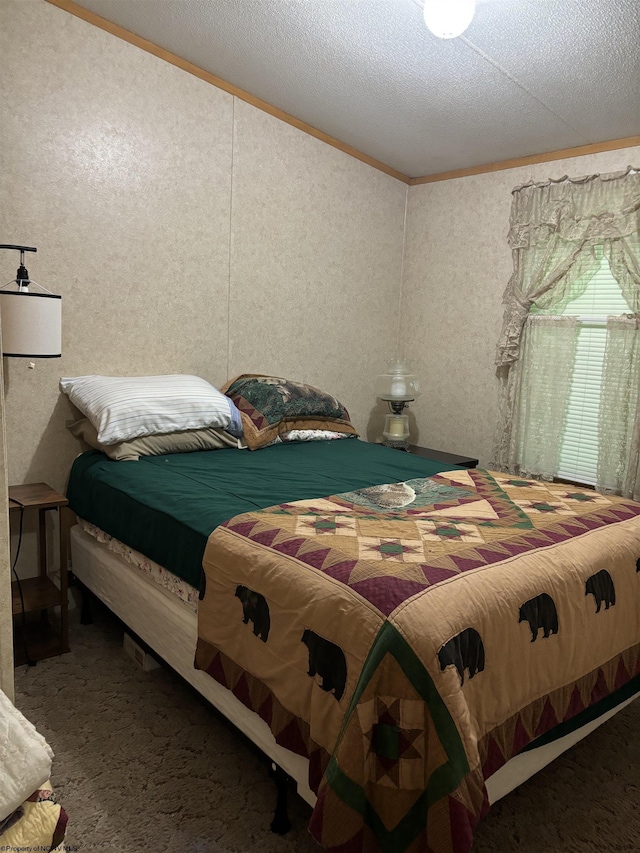 bedroom with carpet, a textured ceiling, and crown molding