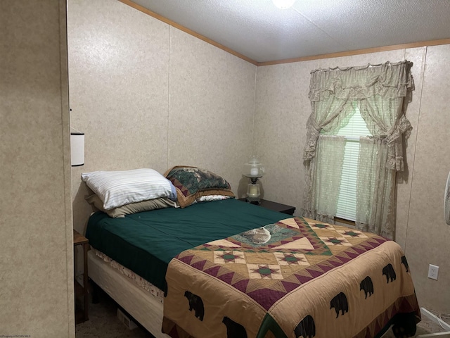 bedroom featuring a textured ceiling and crown molding