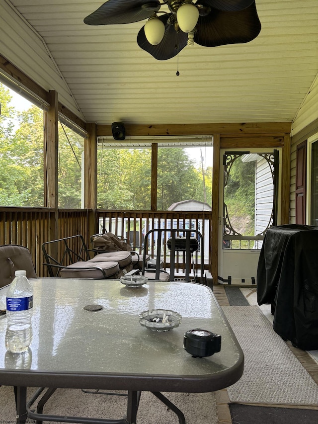 sunroom featuring ceiling fan and vaulted ceiling