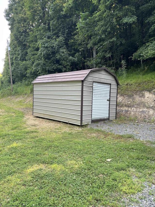 view of outdoor structure with a lawn