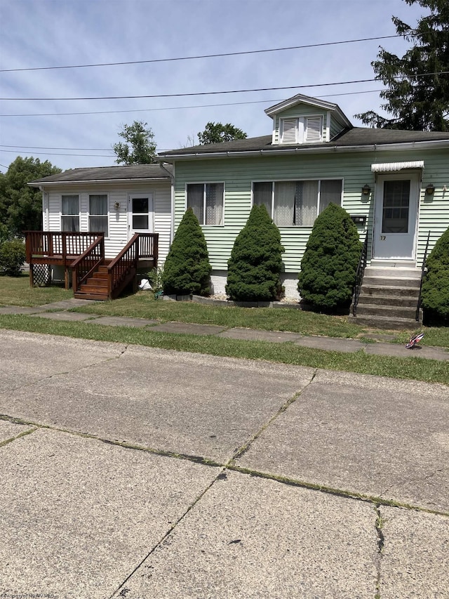 view of front facade with a wooden deck